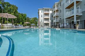 Indian Land apartment for rent - a swimming pool with an apartment building in the background