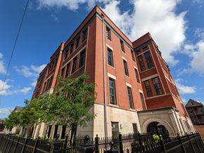 Chicago apartment for rent - a large brick building with a tree in front of it