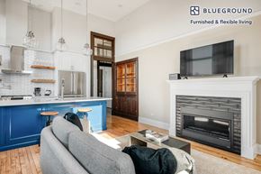 Chicago apartment for rent - a living room and kitchen with a couch and a tv