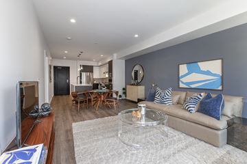 Cupertino apartment for rent - A living room with a grey couch and a coffee table.