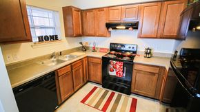Westfield apartment for rent - A kitchen with a black stove top oven and wooden cabinets.