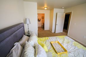 Westfield apartment for rent - A bedroom with a bed, lamp, and a painting on the wall.