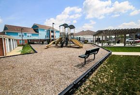 Westfield apartment for rent - A playground with a yellow slide and a green bench.