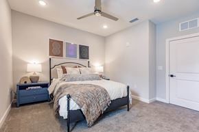 Port Charlotte apartment for rent - a bedroom with a bed and a ceiling fan at  a living room with tables and chairs and a ceiling fan