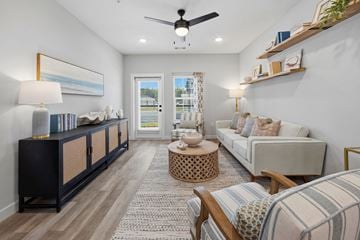 Beaufort apartment for rent - A living room with a striped couch and a round wooden coffee table.