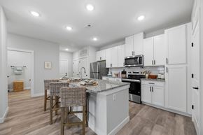 Beaufort apartment for rent - A kitchen with white cabinets and a grey island.