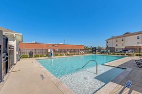 Houston apartment for rent - A swimming pool with a metal ladder in the middle of it.