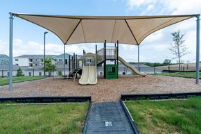 Austin apartment for rent - A playground with a slide and a green box.