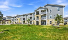 San Antonio apartment for rent - A large grassy area in front of apartment buildings.