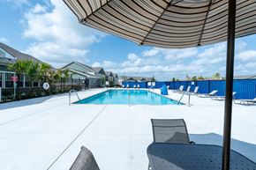 Austin apartment for rent - A pool with chairs and an umbrella