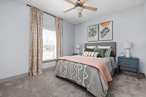 Indianapolis apartment for rent - a bedroom with a bed and a ceiling fan at the Vue apartments in Indianapolis