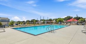 San Antonio apartment for rent - A large swimming pool with a diving board in the middle.