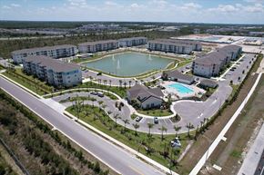Fort Myers apartment for rent - A large resort with a pool and a lake.