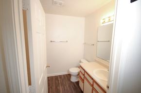 Batesville apartment for rent - A white bathroom with a toilet, sink and mirror.
