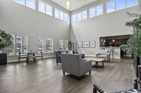 Columbus apartment for rent - A spacious waiting room with a variety of seating options and pictures on the wall.
