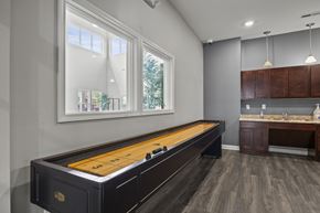 Columbus apartment for rent - A pool table is in the middle of a room with a window and a sink.