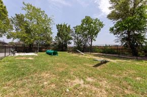 Houston apartment for rent - A green tarp is in the middle of a grassy field.