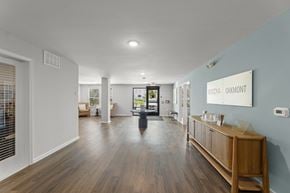 Houston apartment for rent - A hallway with a wooden floor and a white wall with a sign that says "Oakmont".