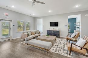 Houston apartment for rent - A living room with a couch, chair, and television.