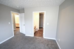 Monticello apartment for rent - Empty bedroom with a white door and gray walls at Canterbury House apartments in Monticello, Indiana