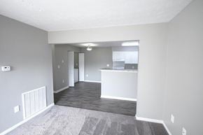 Logansport apartment for rent - Empty living room with a kitchen in the background.