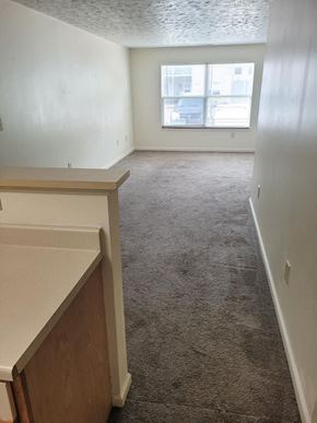Monticello apartment for rent - Empty room with a large window at Canterbury House apartments in Monticello, Indiana