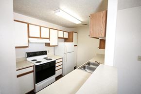 Warsaw apartment for rent - a kitchen with white appliances and cabinets