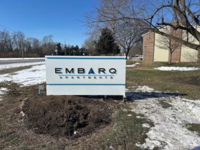 Columbus apartment for rent - A sign for Embark Apartments sits in a mound of dirt.