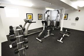 Indianapolis apartment for rent - Fitness center with a treadmill, weight machines and dumbbells at The Enclave at Meridian