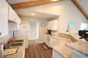La Porte apartment for rent - Clubhouse kitchen with a sink stove and refrigerator at Maple Tree Apartments in LaPorte, IN