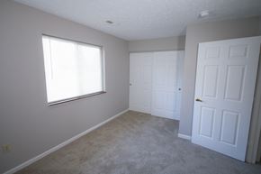 Frankfort apartment for rent - an empty bedroom with two doors and a window at Frankfort Place apartments in Frankfort, Indiana