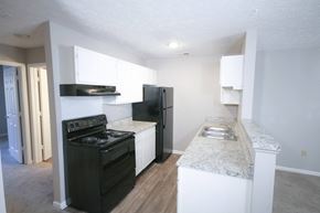Frankfort apartment for rent - an empty kitchen with black appliances and white counter tops at Frankfort Place apartments in Frankfort, Indiana
