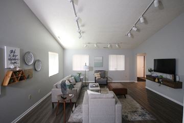 Tipton apartment for rent - A living room with a grey couch and a wooden coffee table.