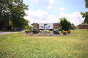 Tipton apartment for rent - Large sign for Hazelton Apartments with plants around it