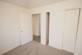 Columbus apartment for rent - a bedroom with two closets and a door to a hallway
