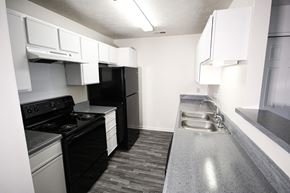 Columbus apartment for rent - a kitchen with black appliances and white cabinets