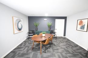 Kokomo apartment for rent - A conference room with a table, chairs, and two potted plants.