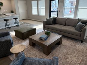 Kansas City apartment for rent - A living room with a grey couch and a coffee table.