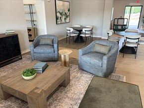 Kansas City apartment for rent - A living room with a grey sofa, a wooden coffee table, and a green rug.