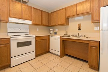 Southgate apartment for rent - A kitchen with wooden cabinets and white appliances.