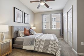 Slidell apartment for rent - a bedroom with a bed and a ceiling fan