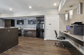 Slidell apartment for rent - an open kitchen and office area with a desk and a chair