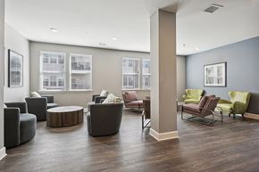 Slidell apartment for rent - a community room with couches chairs and tables and windows at The Lofts apartments in Slidell, LA