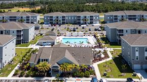 Port Charlotte apartment for rent - A large apartment complex with a swimming pool in the center.