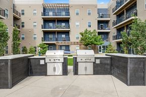 Indianapolis apartment for rent - an outdoor view of two grills in front of The Vue apartments