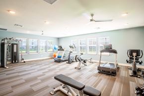 Melbourne apartment for rent - Fitness room with treadmills a bench and elliptical at Trillium apartments in Melbourne fl