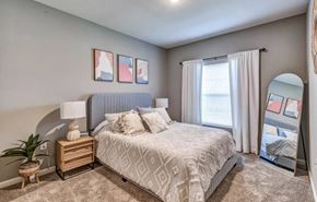 North Port apartment for rent - Bedroom with a large bed and a large window at Flats at Sundown apartments in North Port, Fl