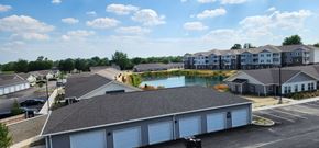 Indianapolis apartment for rent - an aerial view of a building with a pond in the middle