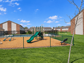 La Porte apartment for rent - A playground with a green slide and a brown fence.