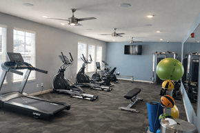 San Antonio apartment for rent - A gym with a variety of equipment including treadmills, exercise bikes, and weightlifting equipment.